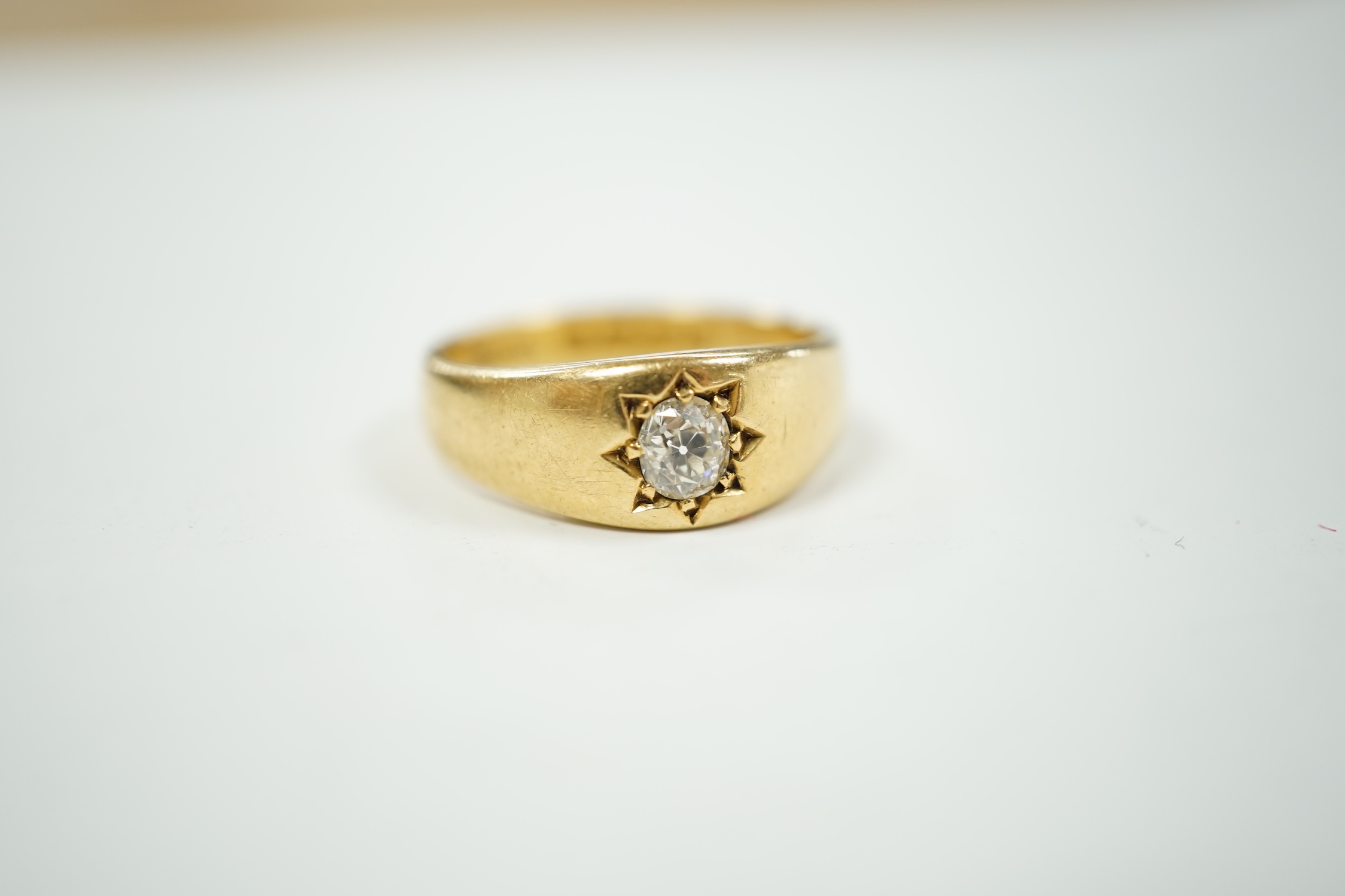 A late Victorian 18ct gold and gypsy set solitaire diamond ring, size Q, gross weight 7.5 grams.